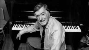 Graeme Bell seated at a piano
