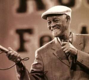 Ibrahim Ferrer singing on stage