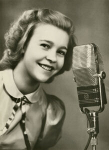 Alice Babs singing at a microphone