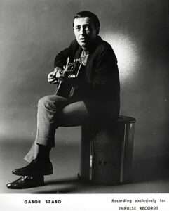 Gábor Szabó seated with guitar
