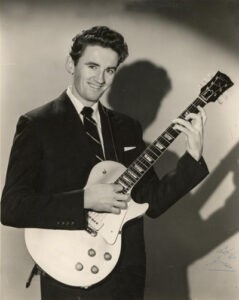 Bruce Clarke holding a guitar