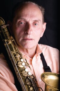 Bobby Wellins holding a saxophone