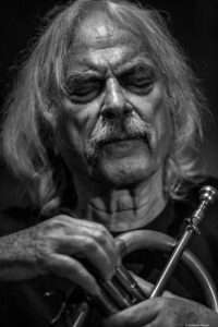Enrico Rava holding a trumpet