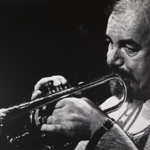 Don Burrows playing trumpet in a black and white portrait