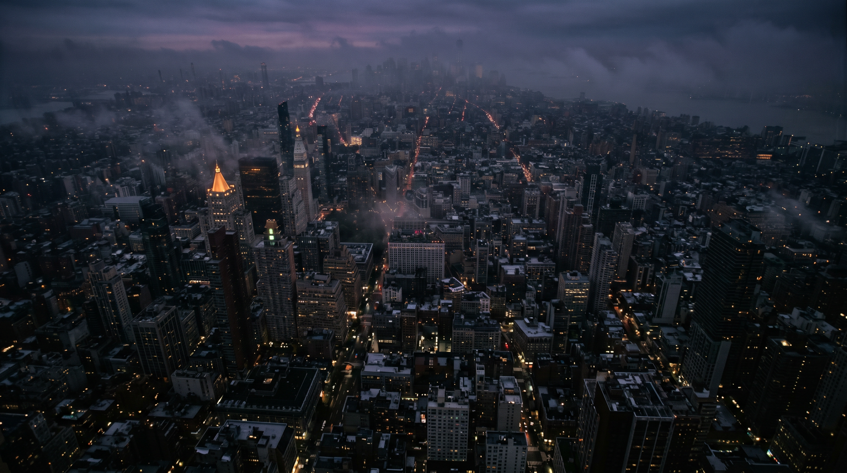 Cinematic aerial view of a city at dusk covered in mist