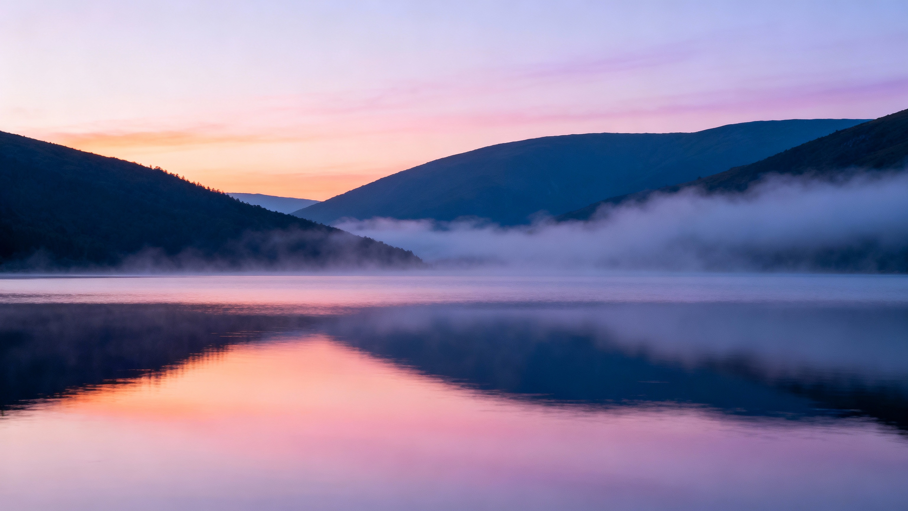 Serene mountain landscape at sunset representing peace and relief