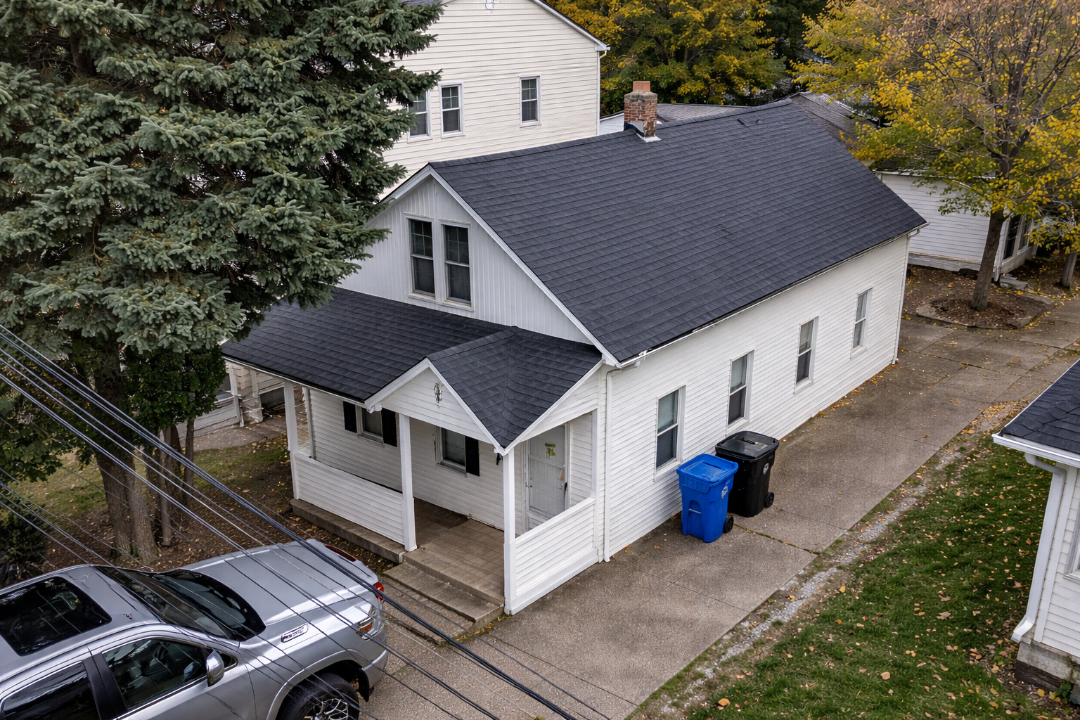 New dark shingle roof replacement on a white craftsman home — Northeast Ohio