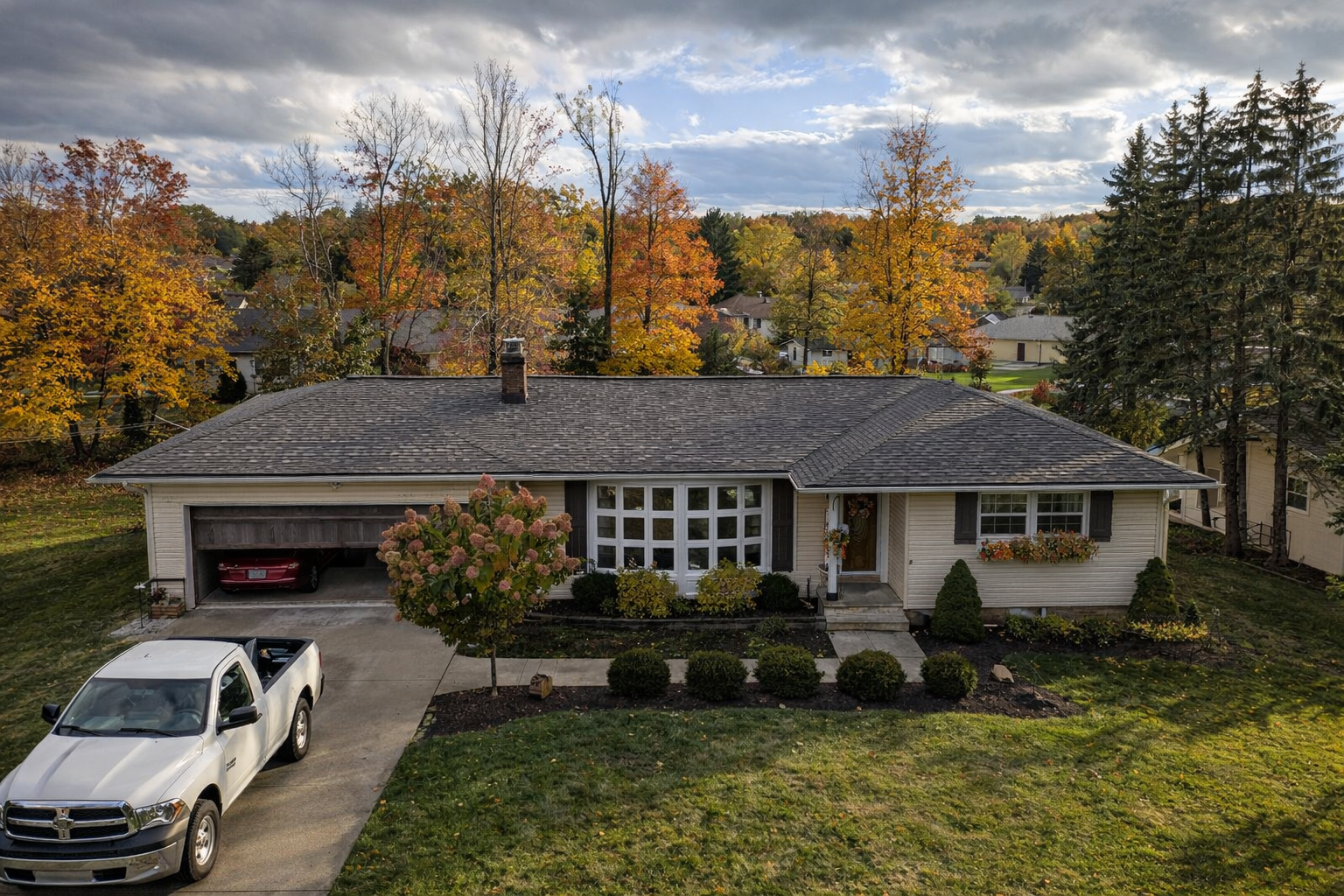 Aerial view of completed charcoal shingle roof on a ranch home with fall foliage — Northeast Ohio