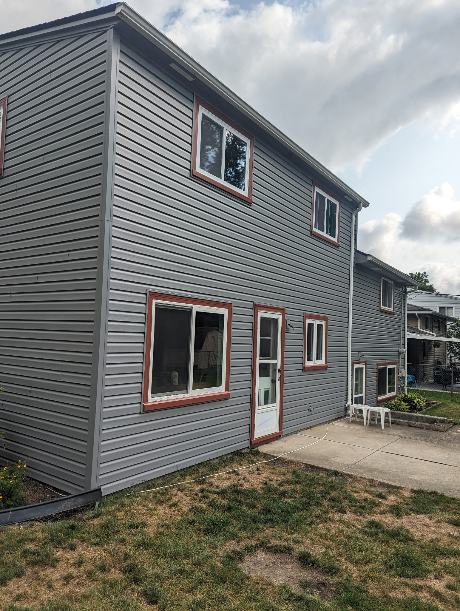 New gray vinyl siding installation on a two-story home — Northeast Ohio