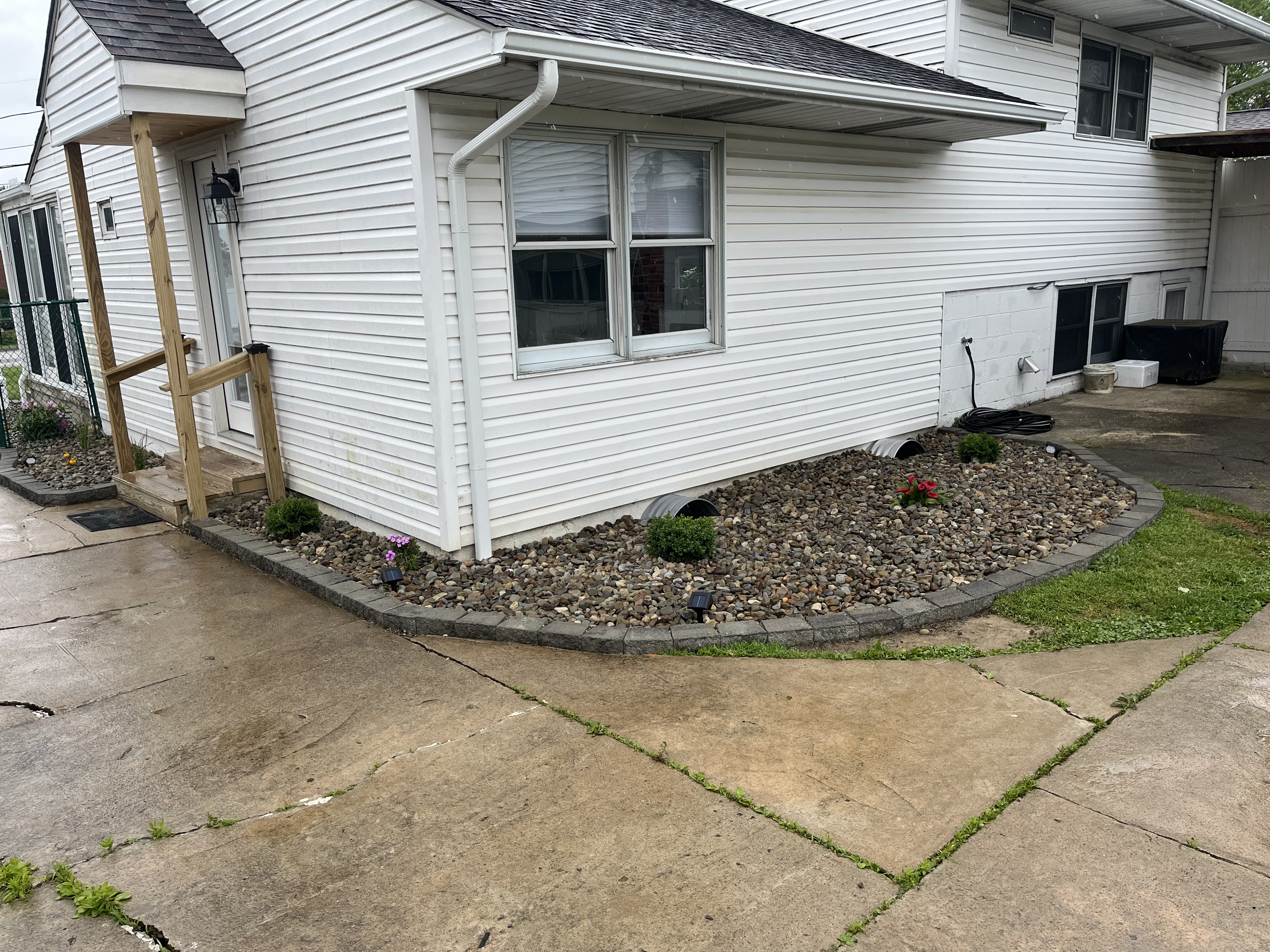 Exterior rock bed and siding cleanup