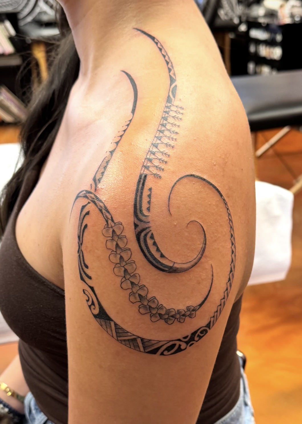 Polynesian floral shoulder tattoo by Marc Cabos