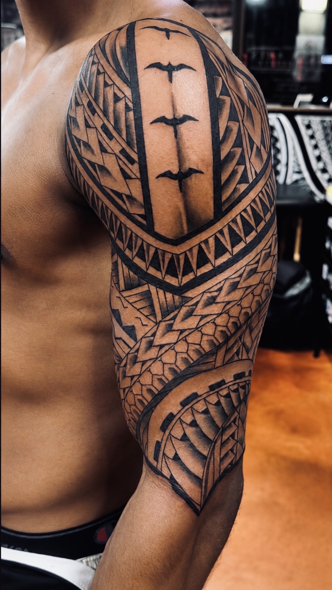 Marc Cabos Polynesian shoulder and arm tattoo