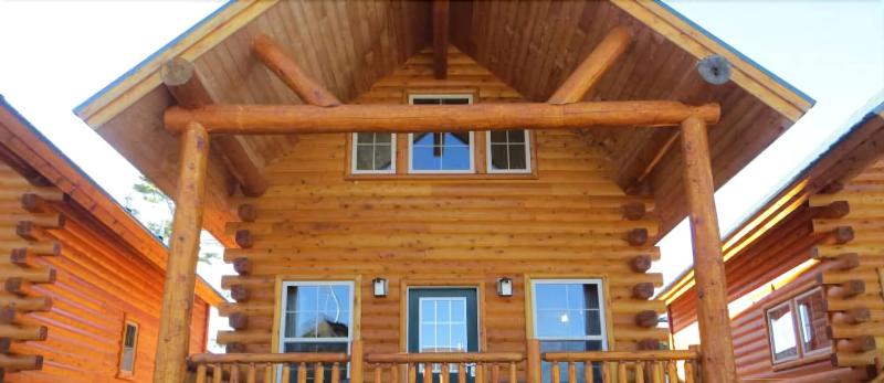 Classic log cabin facade at Cabins of Mackinaw nestled in Mackinaw City