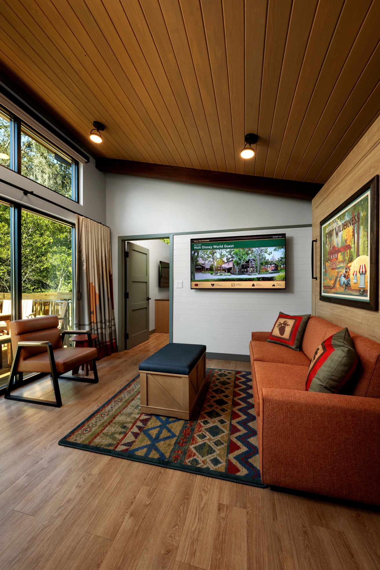 The living room of a cabin at Disney's Fort Wilderness Resort featuring rustic decor and comfortable seating