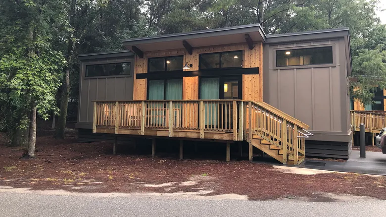Modern cabin exterior at Disney's Fort Wilderness with wood siding and front porch