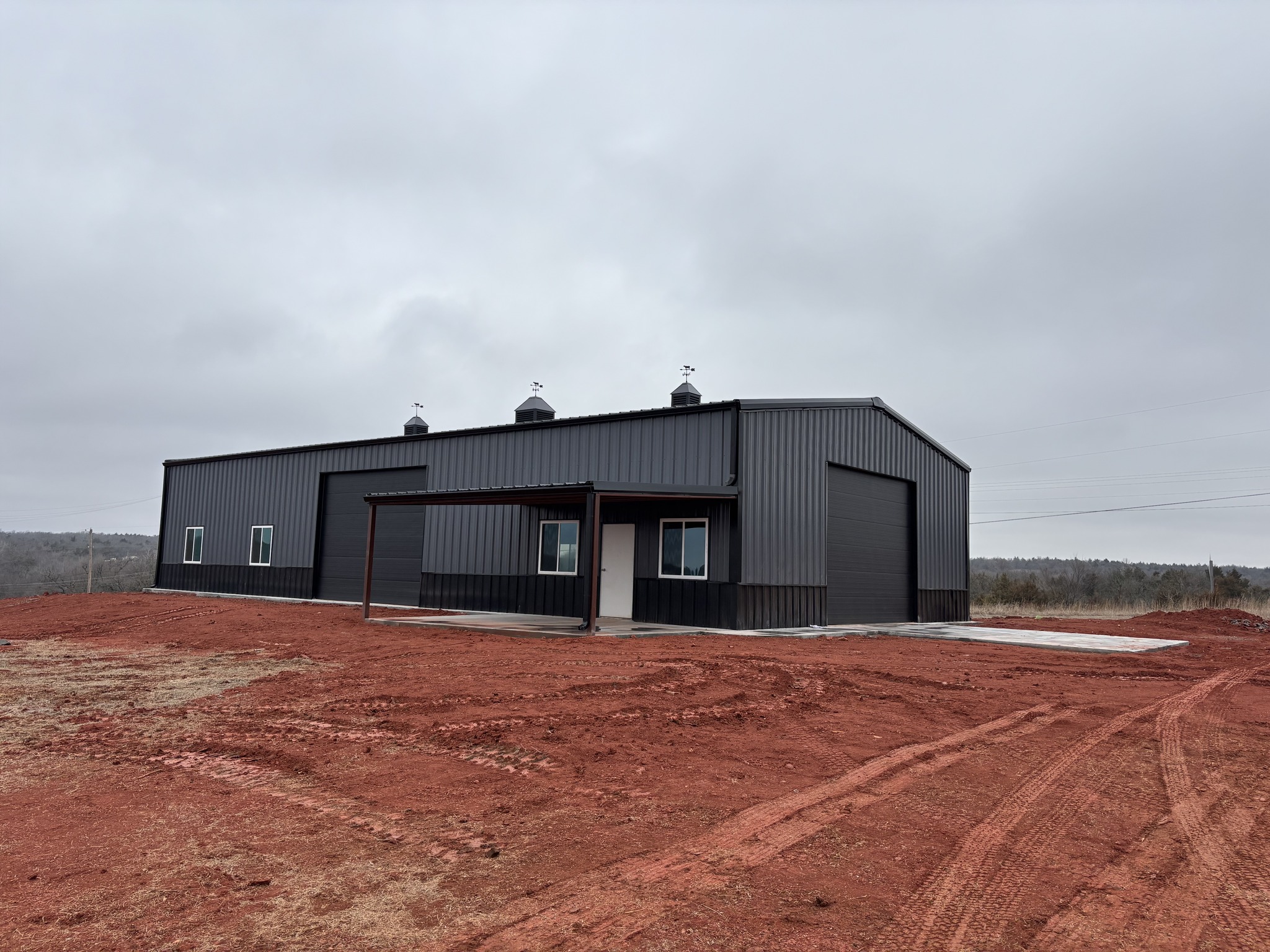 Dark panel custom steel metal building constructed by OK Steel LLC near Oklahoma City