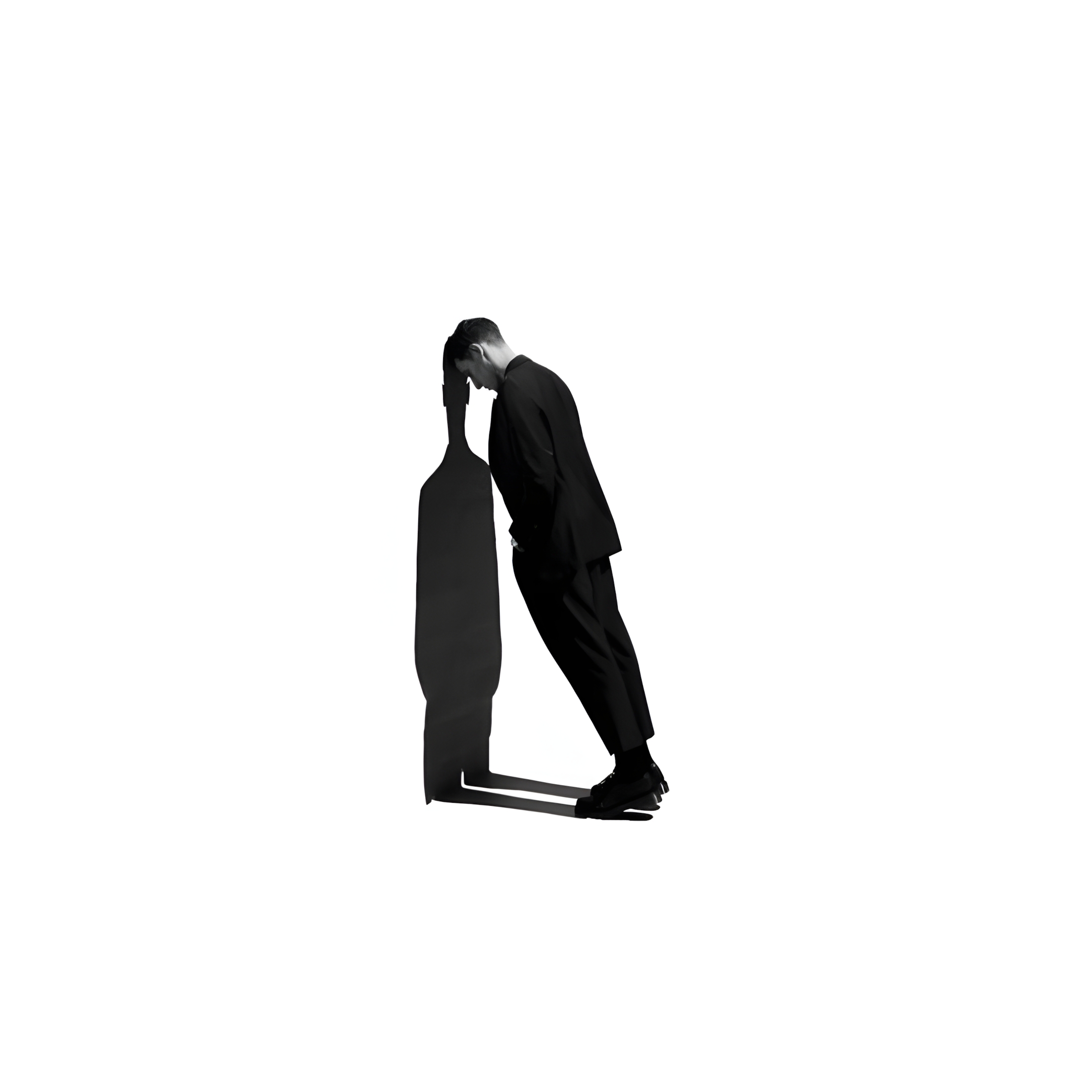A person in a suit leaning forward exhausted, representing the overwhelm of a chaotic workload