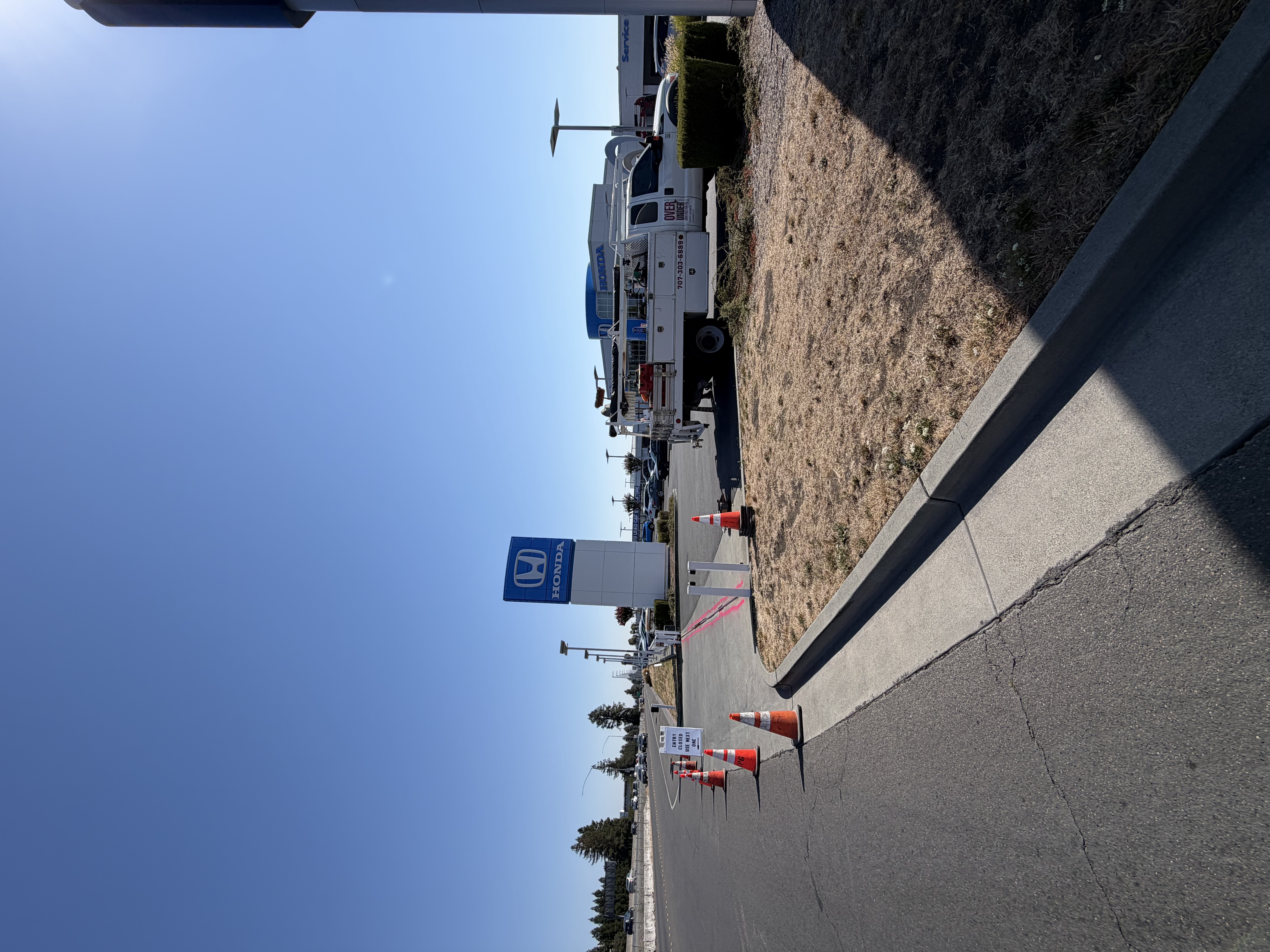 Over & Under Construction truck at a paved commercial site