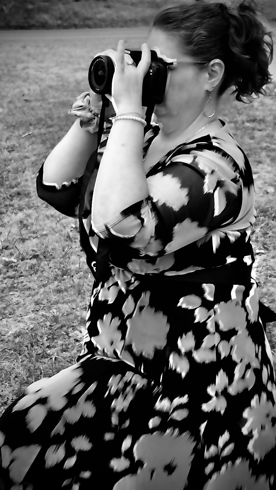 A photographer holding a camera outdoors