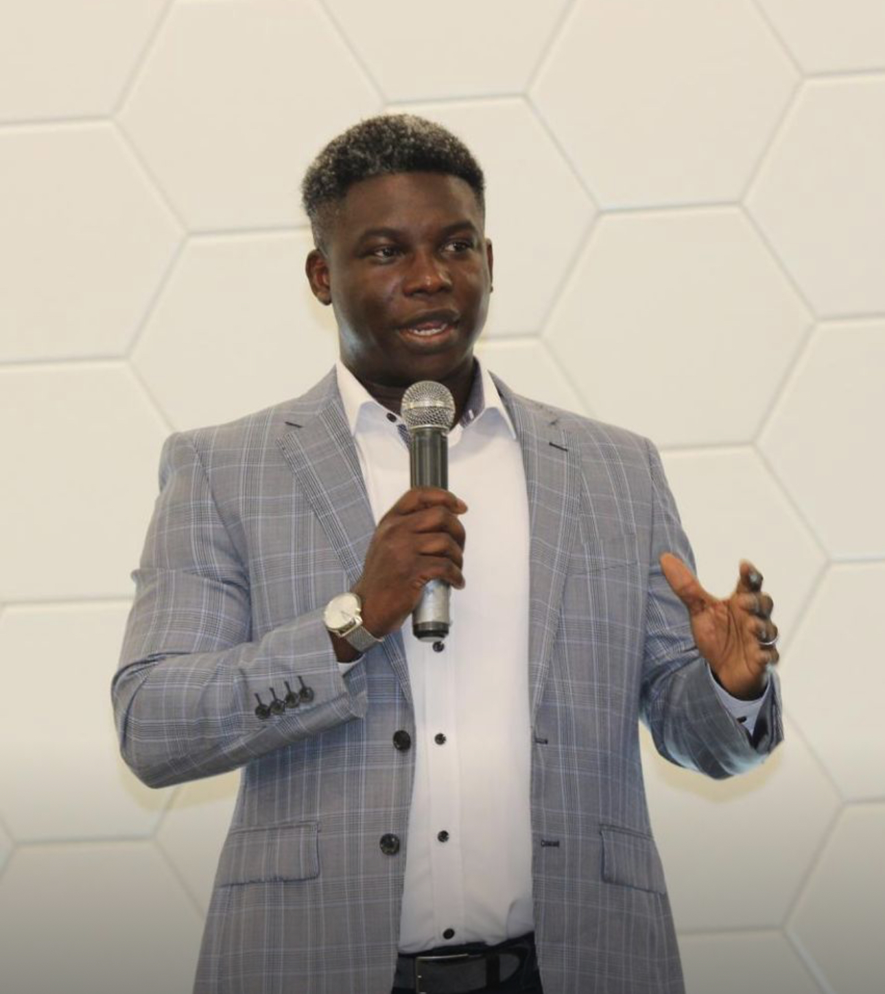 Sam Ayeni speaking with a microphone