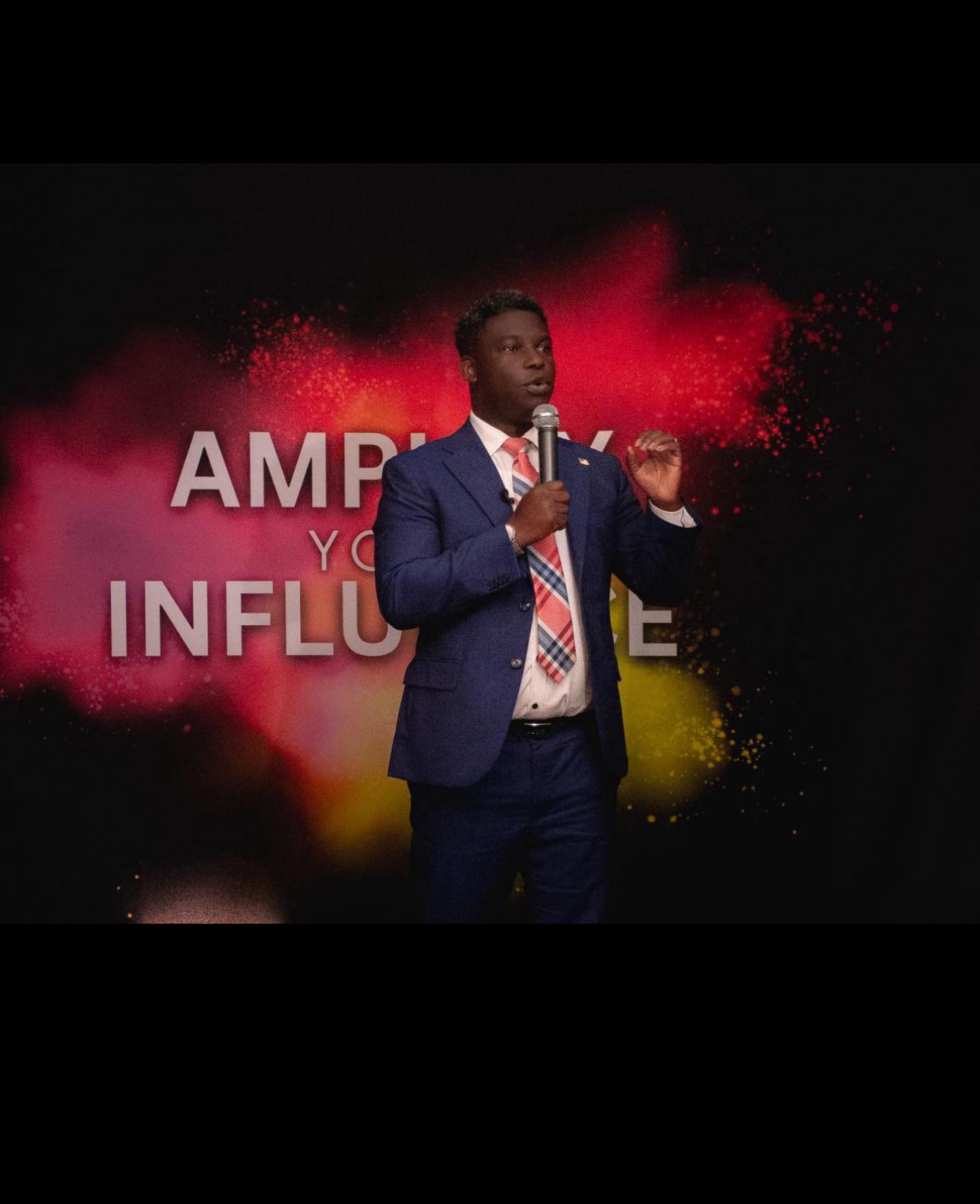 Sam Ayeni presenting on stage