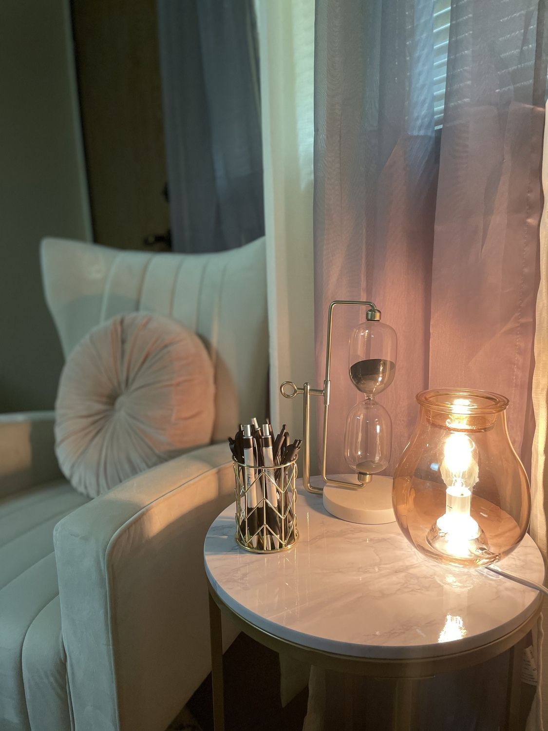 Cozy therapy room with comfortable chair, warm lamp and curtains