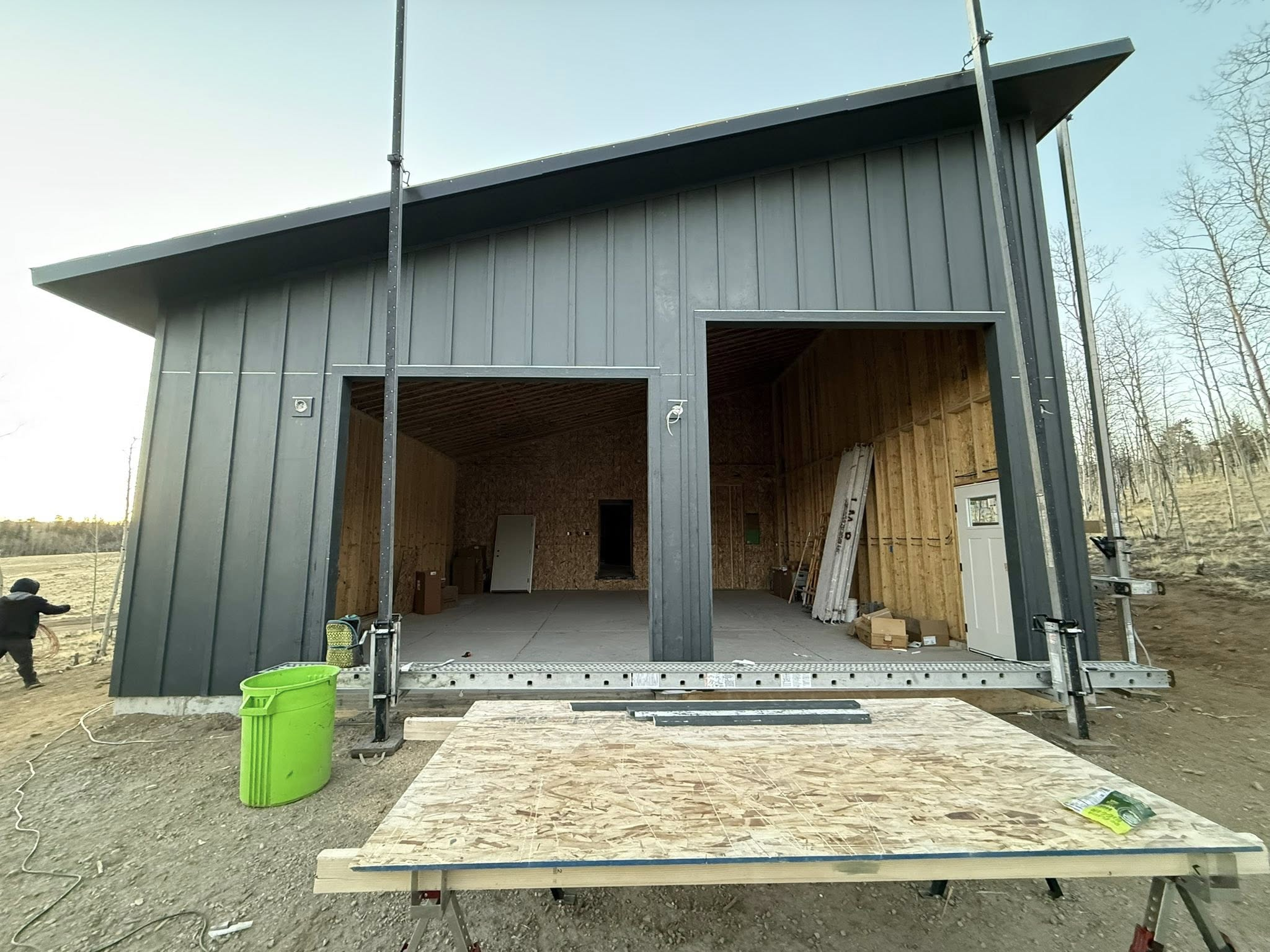Custom barn build with metal siding and large garage doors