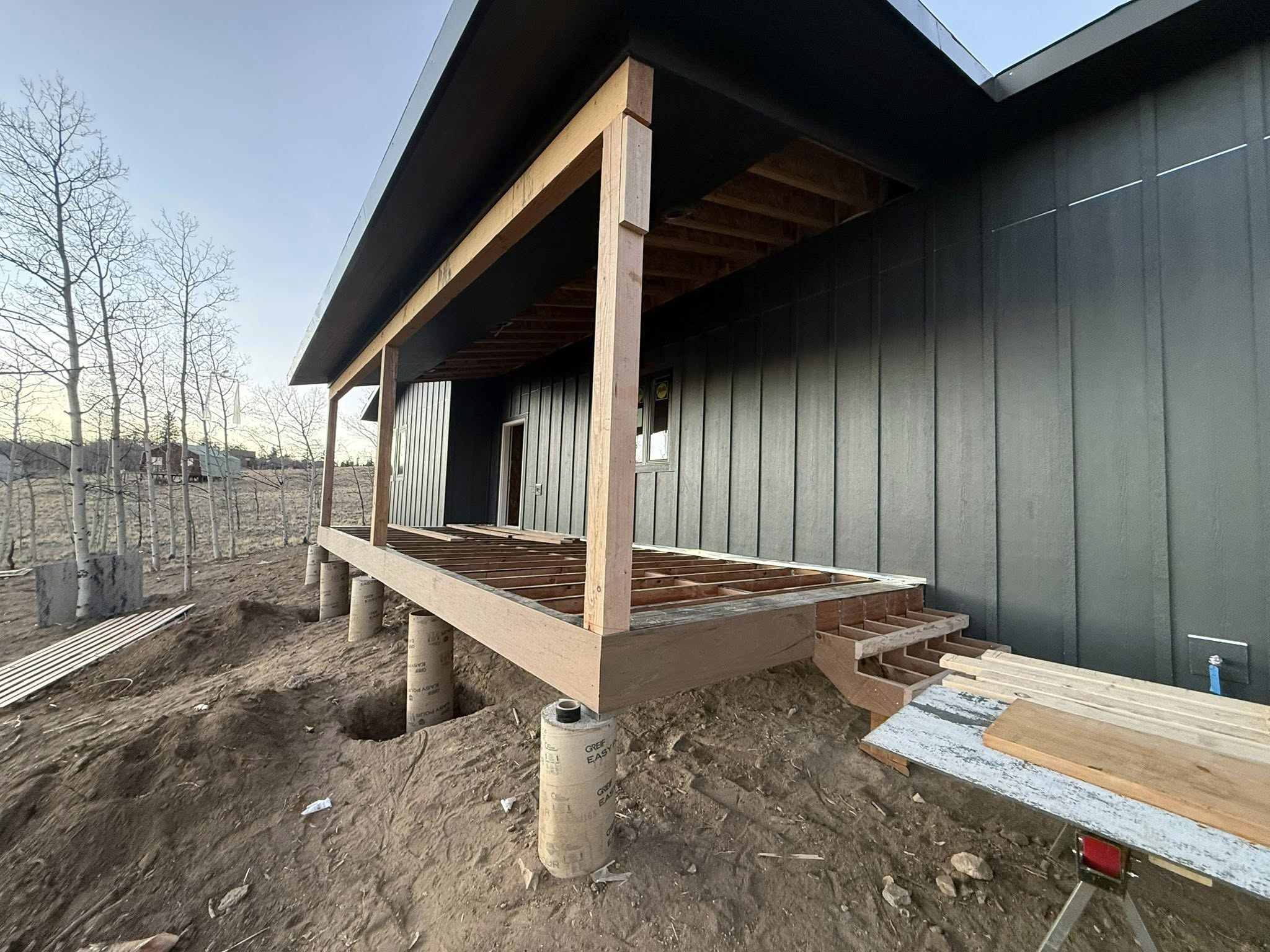 Deck framing construction with timber posts and concrete footings