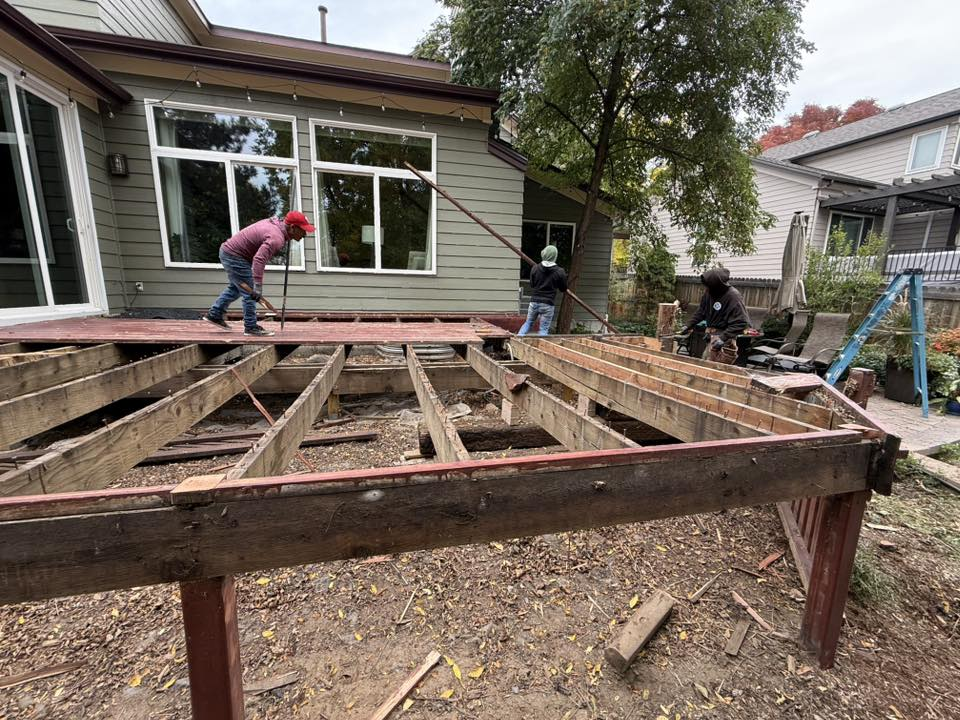 Deck demolition crew removing old deck boards and frame