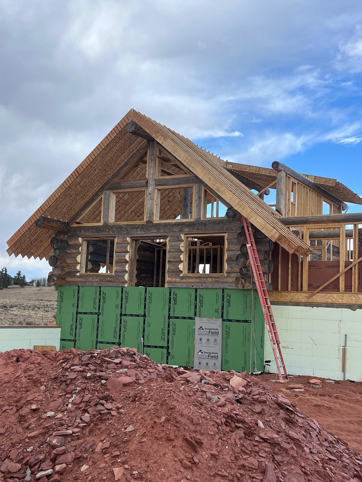 Log cabin construction with A-frame roof framing and ZIP system sheathing