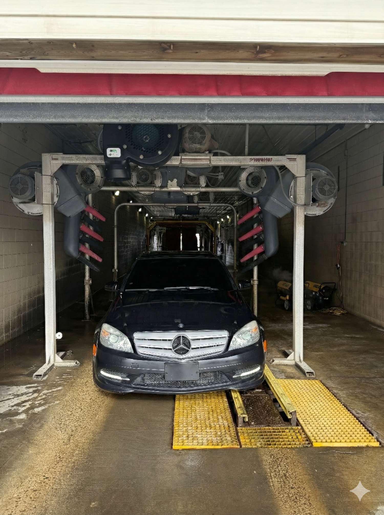 Vehicle inside the automatic car wash bay at All Seasons Car Wash