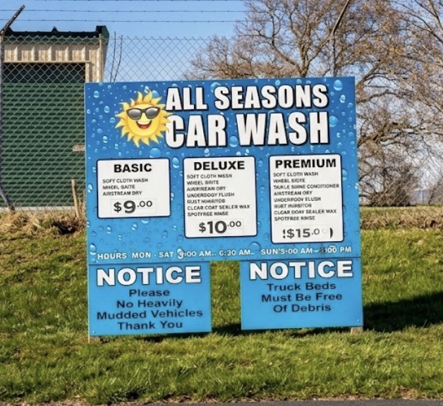 All Seasons Car Wash roadside sign showing basic, deluxe, and premium wash packages and prices