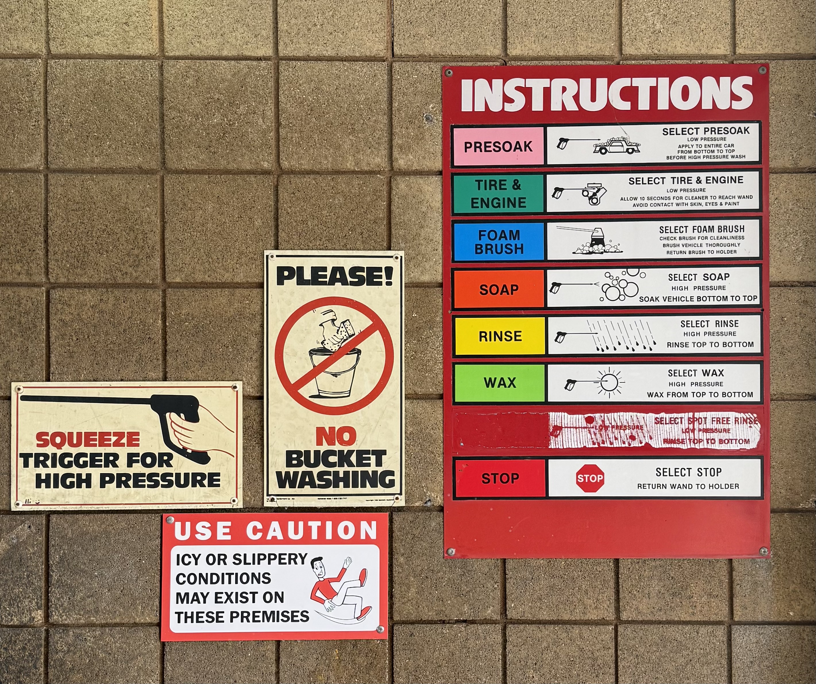 Instruction signs inside the self-serve bay at All Seasons Car Wash, showing wash steps and safety notices