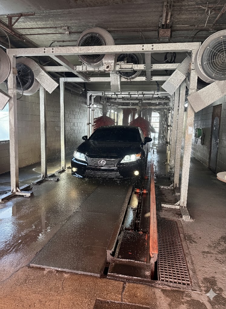 Black Lexus driving through the dryer section of the tunnel