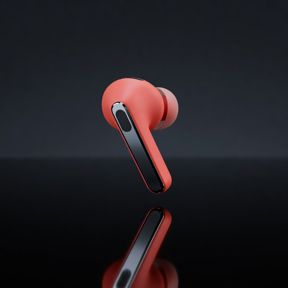 Coral wireless earbud floating above a reflective black surface