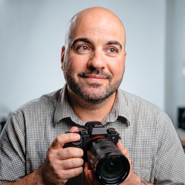 Portrait of Thiago Navarro holding a professional camera
