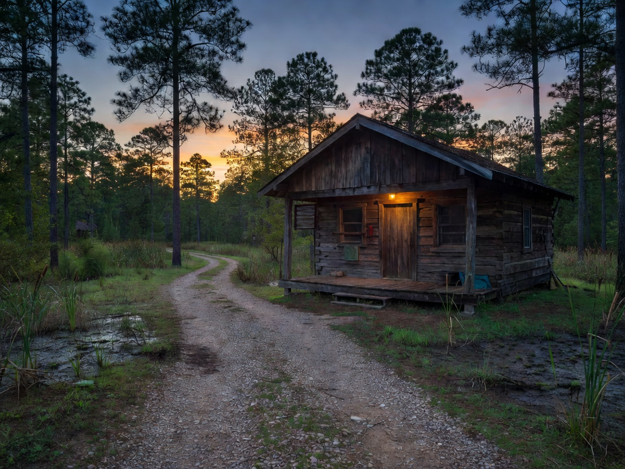Rustic hunting camp cabin at dusk