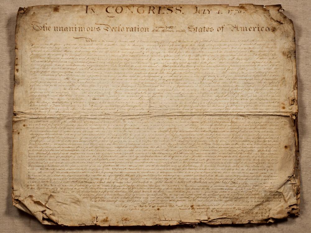 Sepia depiction of a historic Declaration of Independence manuscript on aged parchment