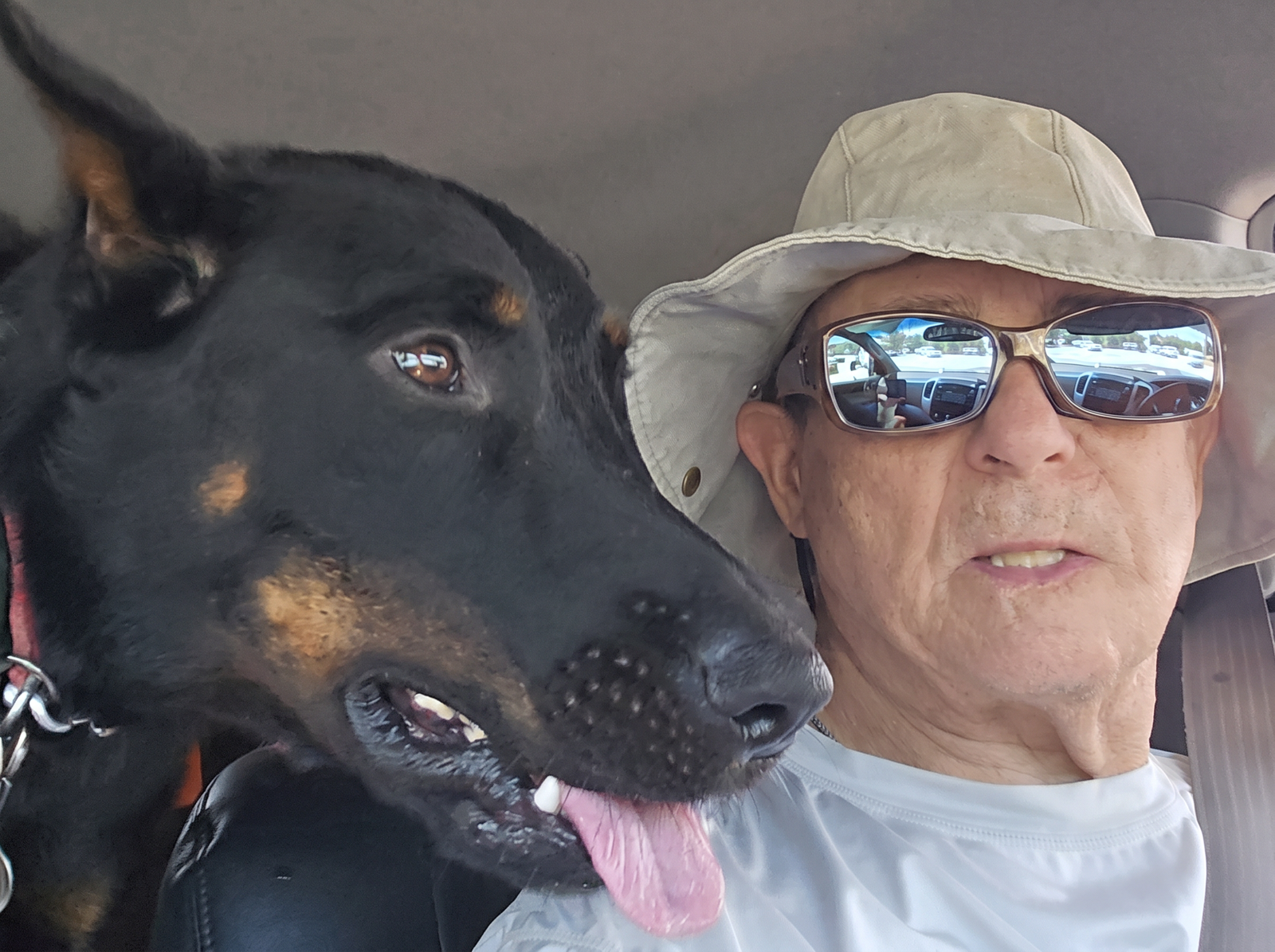 Earl sitting in his truck with his two dogs beside him