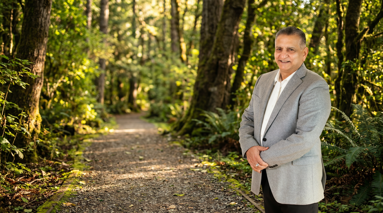 Paul Sahota standing near a forest pathway