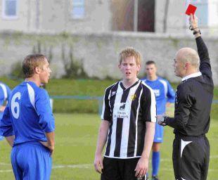 Football referee showing a red card to a player during a match