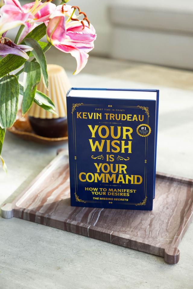 Your Wish Is Your Command book on a table beside flowers
