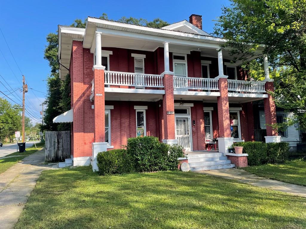 Wider angled view of the Wellstone home in Columbus, Georgia showing full brick facade and porch