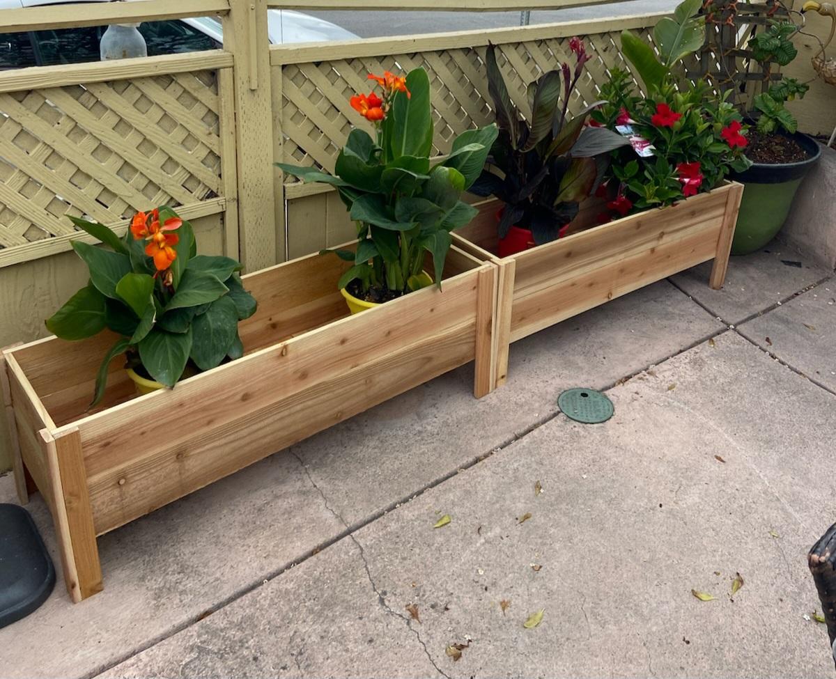 Finished wooden raised planter boxes with flowers