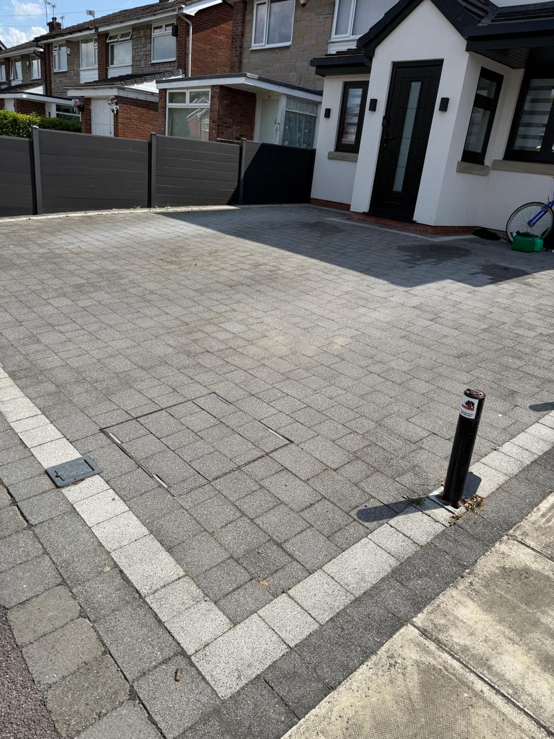 Before photo of a paved driveway before outdoor surface clean-up