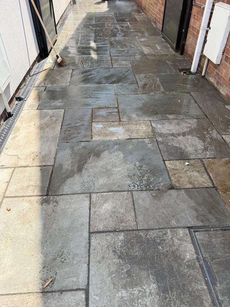 Before photo of a wet, marked paved side path with a broom nearby