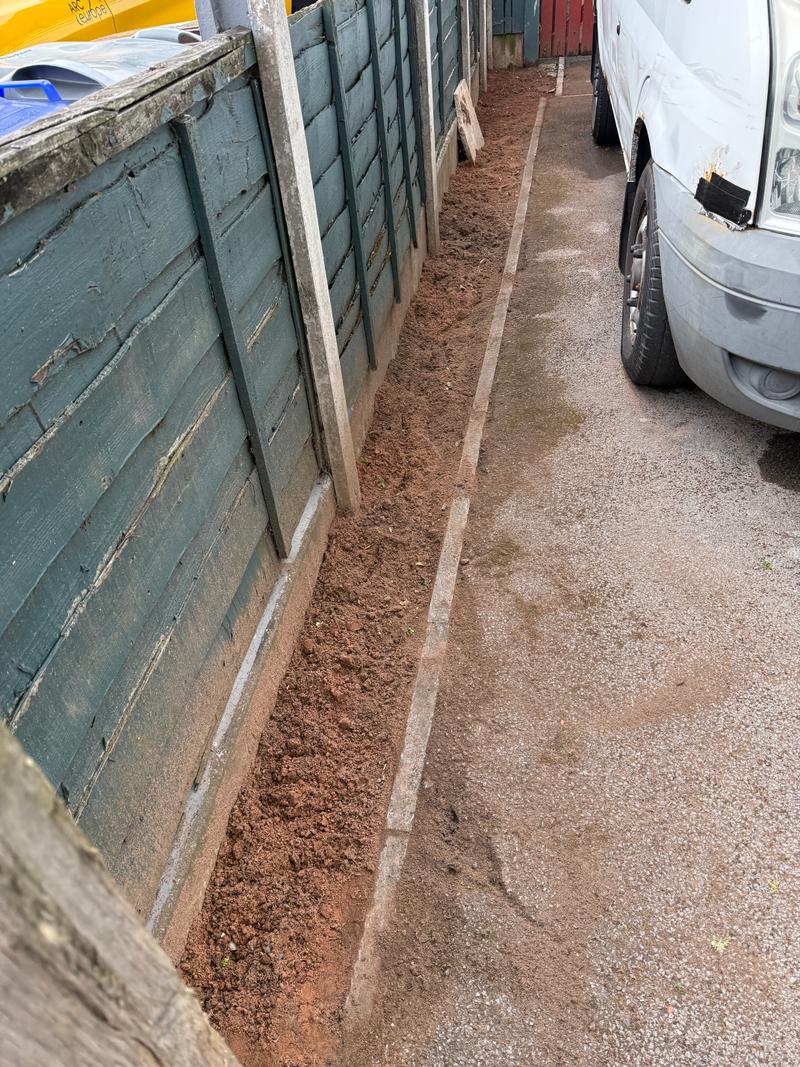 After photo of a cleared outdoor border with exposed soil