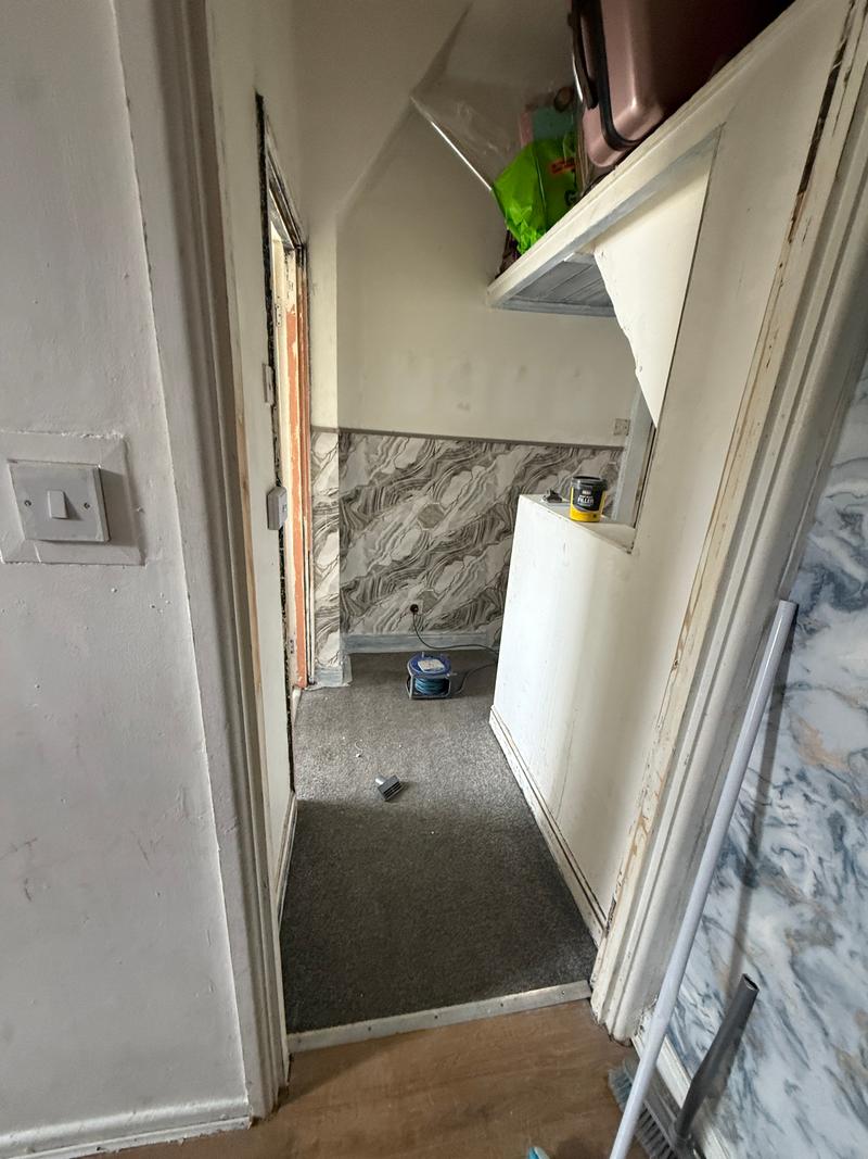 Before photo of a hallway and landing during preparation for decorating
