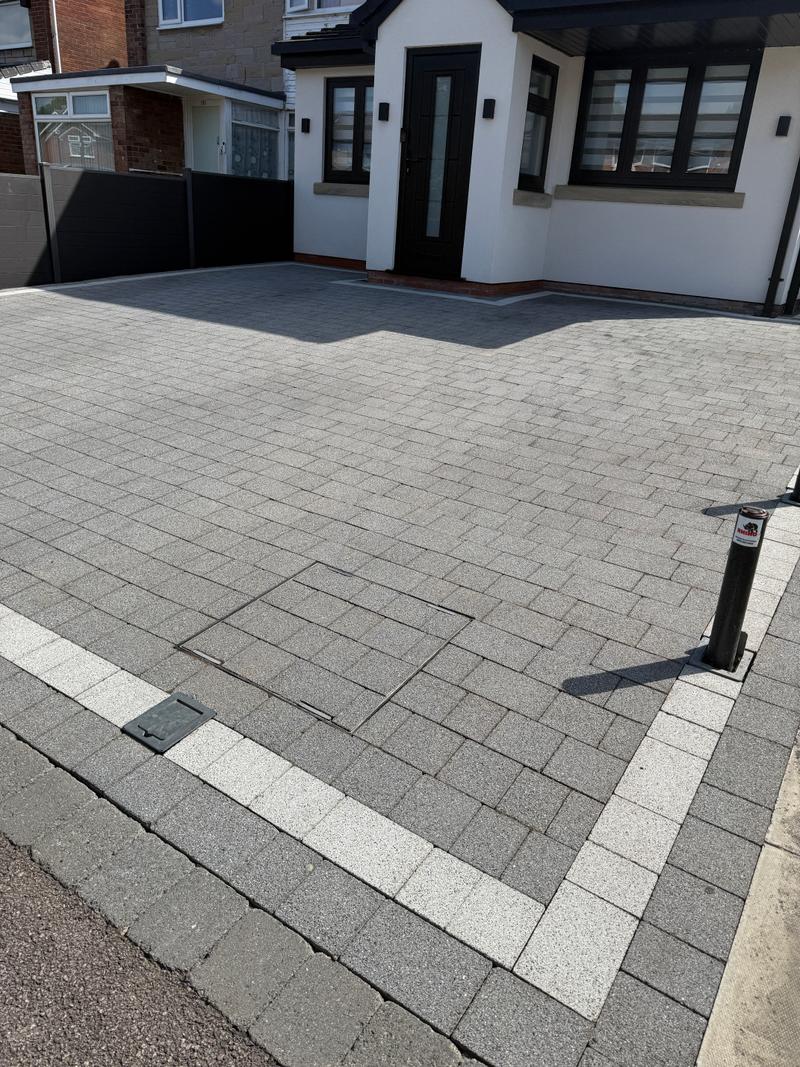 After photo of a cleaner, lighter paved driveway following clean-up