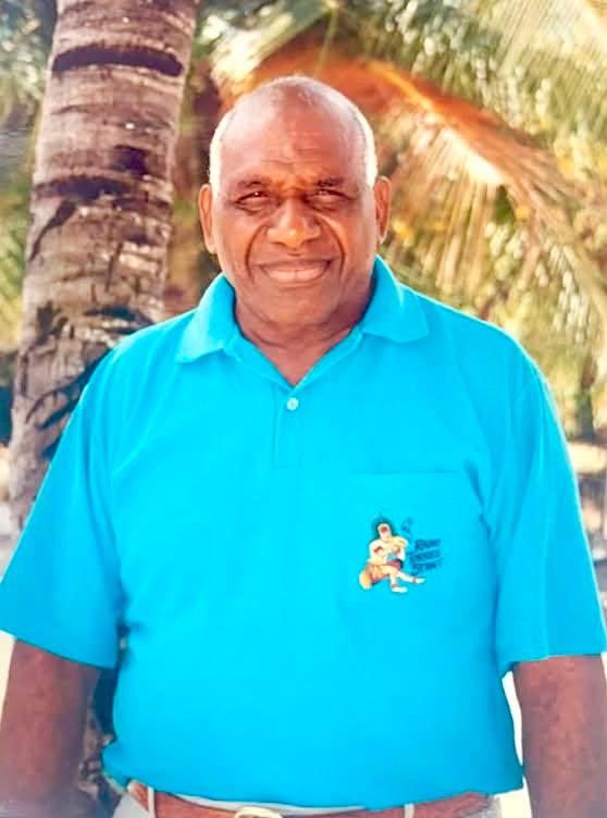 Dad standing outdoors in a bright blue shirt.